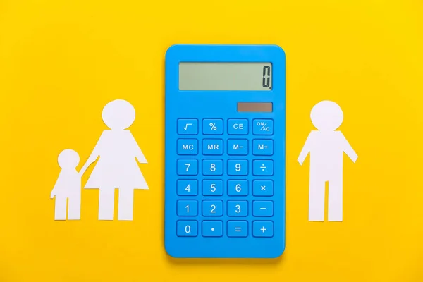 Broken family, divorce. Property division concept. Split paper family, calculator on yellow background