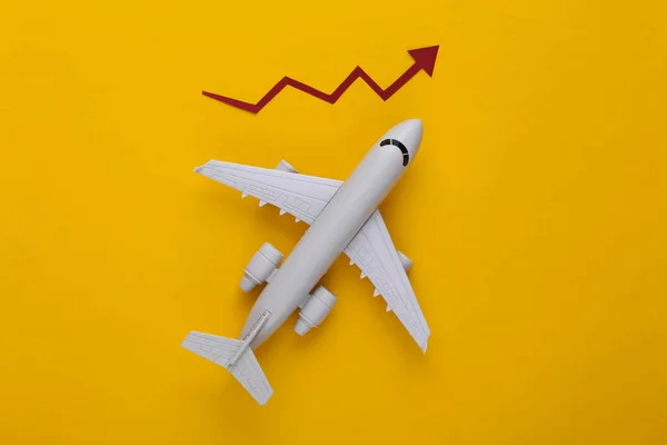 Airplane with growth arrow on a yellow background. Top view