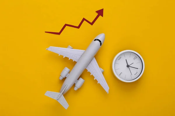 Airplane with growth arrow and clock on a yellow background. Top view
