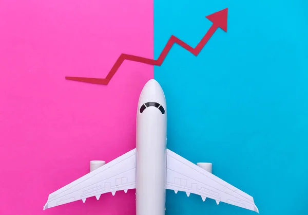 Airplane with growth arrow on pink blue background. Top view