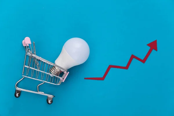 Shopping Trolley Light Bulb Growth Arrow Blue Background Top View — Stock Photo, Image