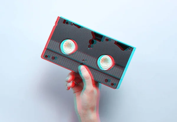 Hand Holds Video Cassette Gray Background Retro Style Glitch Effect — Stock Photo, Image