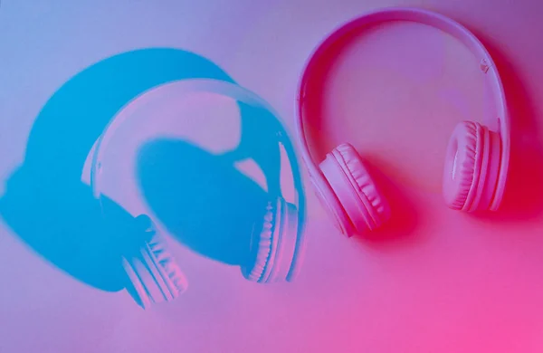 Headphones. Retro wave, neon light, ultraviolet. Top view, minimalism Glitch duotone effect