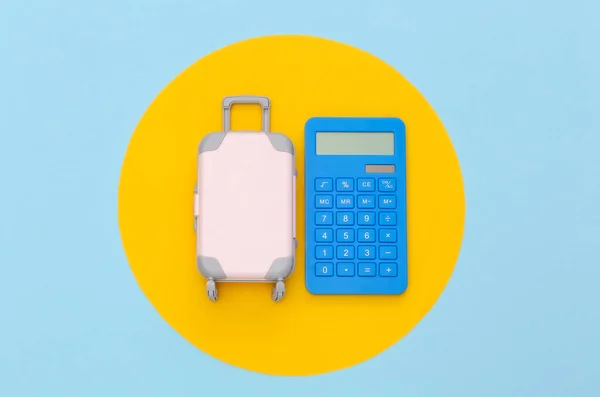 Travel Expenses Mini Plastic Travel Suitcase Calculator Blue Background Yellow — Stock Photo, Image