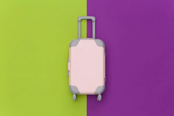 Travel Concept Mini Plastic Travel Suitcase Green Purple Background Minimal — Stock Photo, Image