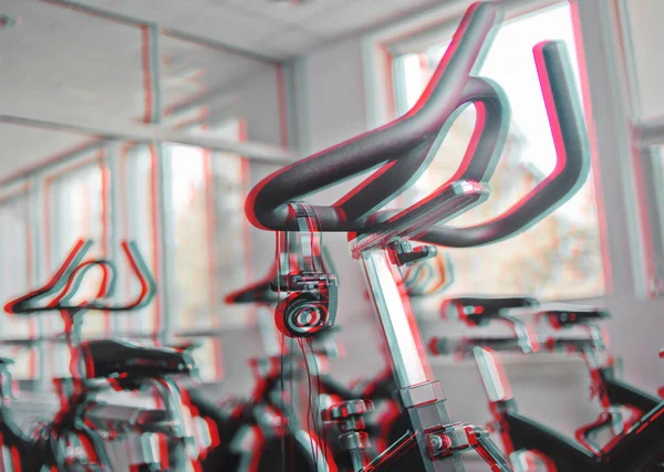 Headphones hanging on a stationary bike at spinning class