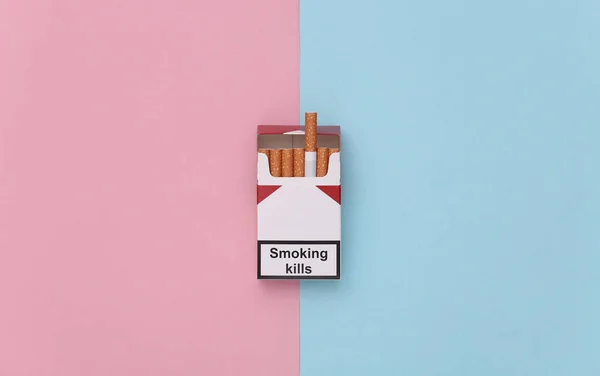 粉红蓝色背景的香烟包 吸烟使人死亡 顶部视图 — 图库照片