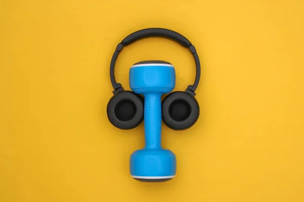 Dumbbell Stereo Headphones Yellow Background Sport Concept Top View — Stock Photo, Image