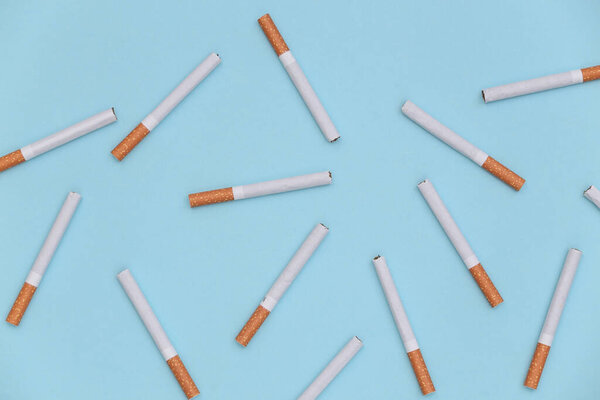 Background from many cigarettes on a blue background.