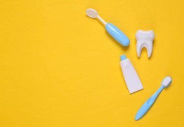 Oyuncak dişçi ekipmanları sarı arka planda. Uzayı kopyala Üst Manzara. Düz yatıyordu