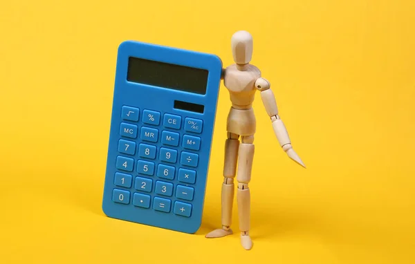 Wooden Puppet Calculator Yellow Background Costing Economics — Stock fotografie