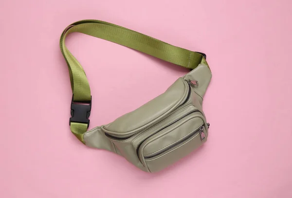 Waist banana bag on a pink background. Top view
