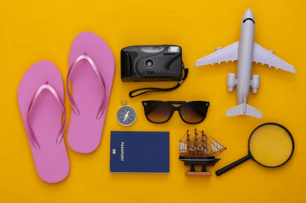 Travel flat lay. Travel accessories on yellow background. Minimal style. Top view