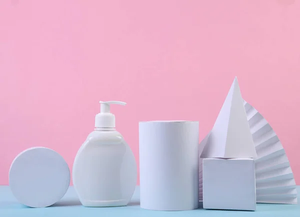 Beauty still life. Product presentation. Cream bottle and geometric shapes on a blue-pink pastel background. Minimalism, Concept art