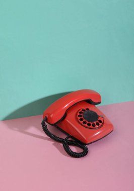 Yaratıcı retro 80 'ler natürmortu. Pembe mavi pastel arka planda geri dönüşlü telefon. Minimalizm. Moda gölgesi.
