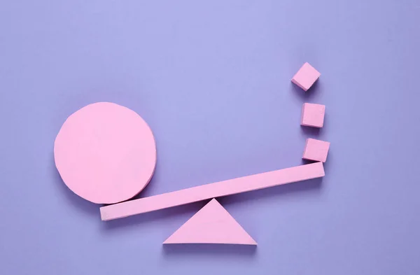 Balancing swing with cube and circle on pink background. Minimalism. Geometry shapes. Creative layout