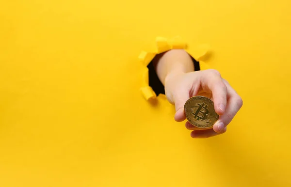 Female Hand Holds Bitcoin Torn Hole Yellow Paper Concept Art — Stock Photo, Image
