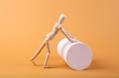 Kukla, bej arkaplanda silindir yuvarlar