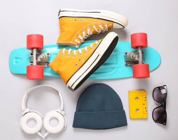 Hipster outfit on gray background. Youth flat lay still life