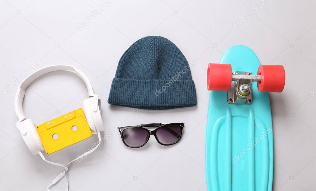 Hipster outfit on gray background. Youth flat lay still life