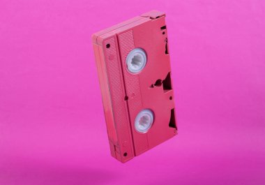 Pembe arka planda pembe video kaset. Minimalist natürmort. Yaratıcı düzen. Sanat kavramı