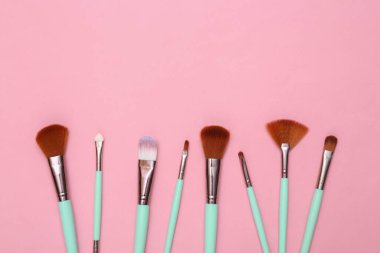 Makeup brushes on pink background. Beauty layout. Flat lay. Minimalism