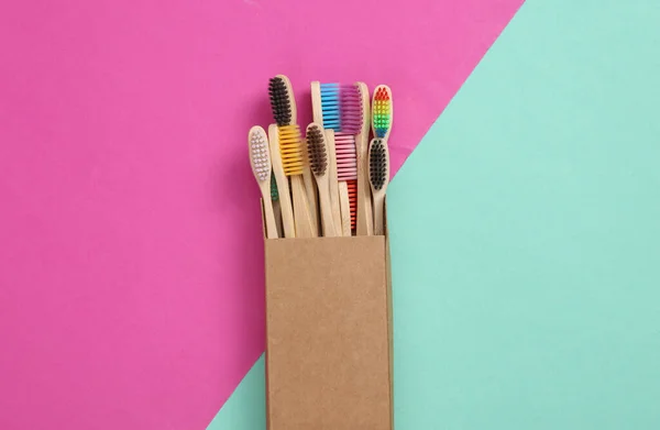 Many Eco Friendly Bamboo Toothbrushes Cardboard Box Pink Blue Background — Stock Photo, Image