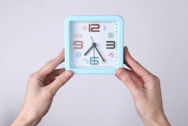 Beyaz arkaplanda eller alarma bassın