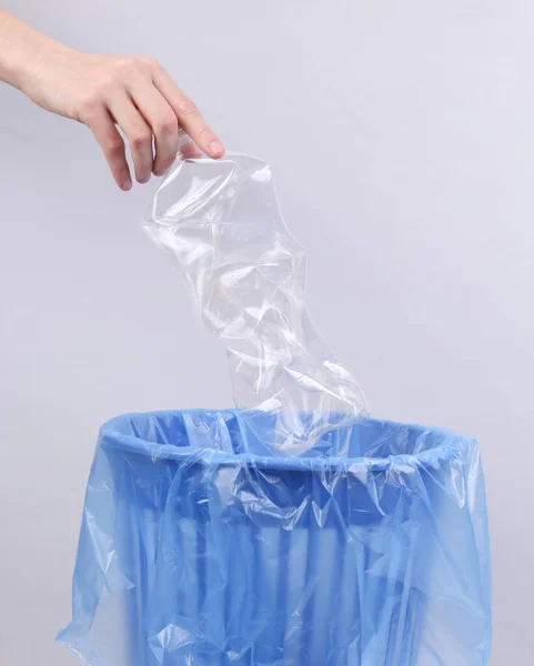 Hand Throws Crumpled Plastic Bottle Trash Bin Package Gray Background Stock Photo