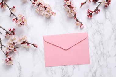 Zarf ve mermer arka planda güzel çiçekli dallar. Düz yatış, üst görünüm.