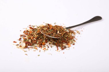 Baharat karışımı, beyaz arka planda izole edilmiş kaşıkla yemek pişirmek için doğal baharat.
