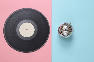 Pembe arka planda disko topu olan Retro vinil plak. Minimalizm partisi konsepti