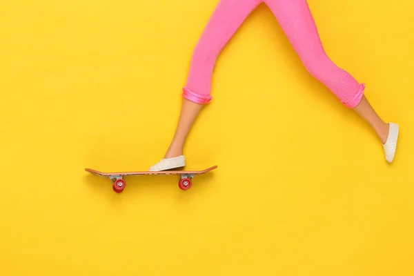 Doll Legs Ride Skateboard Yellow Background Minimalism — Stock Photo, Image