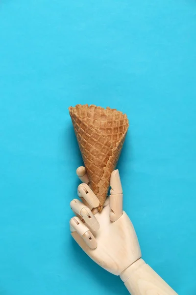 Wooden Hand Holding Empty Waffle Cone Blue Background — Stock Photo, Image