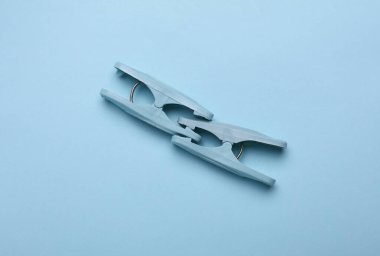 Plastic clothespins on a blue backgroun