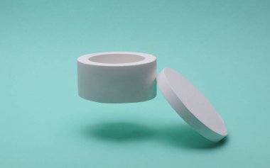 White plaster candle box on blue background