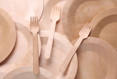 Beyaz arka planda bir dizi ahşap eko tabak. Çatallı tabaklar