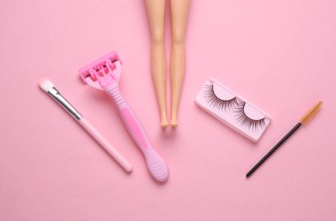 DAll hand False eyelashes, razor, makeup brushes on pink background. Beauty concept. Flat lay