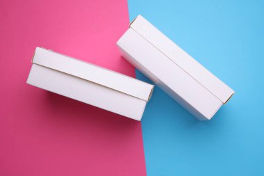 Pembe arkaplanda beyaz karton kutular