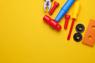 Sarı arka planda bir grup çocuk oyuncağı. Düz yatıyordu