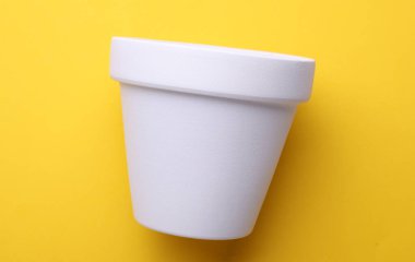 White empty clay flowerpot on yellow background. Mockup for design