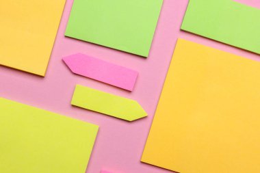 Çeşitli boş kağıt çıkartmaları var. Çok renkli. Mavi arkaplanda yapışkan not koleksiyonu