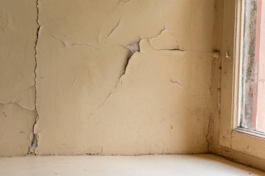 Çatlak duvarlı ve boyalı eski bir ev.