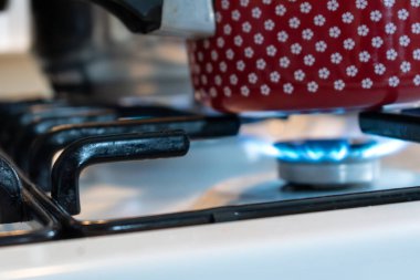 Gaz ocağında tencere, mutfakta fırın.