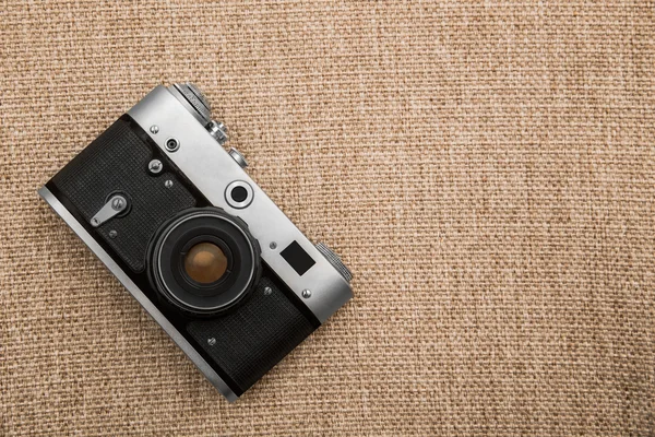 Vintage camera on the background of old fabric — Stock Photo, Image