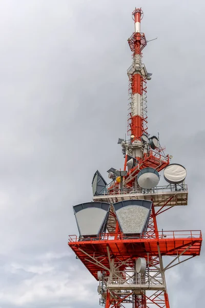 A part of communication tower with control devices and antennas, transmitters and repeaters for mobile communications and the Internet. Vertical view