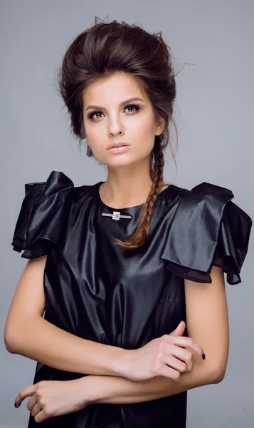 Portrait of young beautiful woman in leather black  dress with natural beauty, nude makeup, hairstyle — Stok fotoğraf