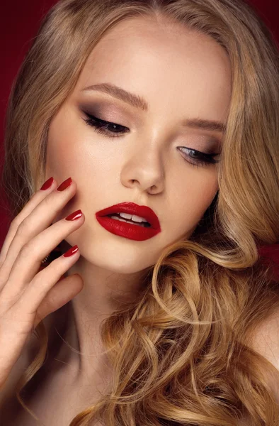 Beautiful face of a fashion model with blue eyes.Curly hair. Red lips. Studio portrait. — Stock Photo, Image