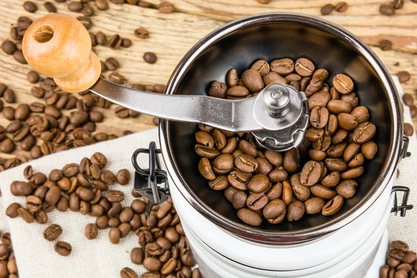 Vintage coffee grinder mill with coffee beans. — Stock Photo, Image