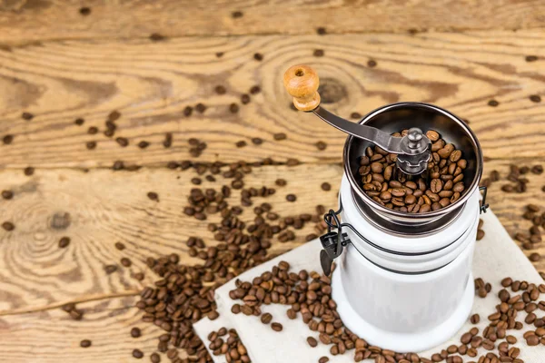 Vintage coffee grinder mill with coffee beans. — Stock Photo, Image